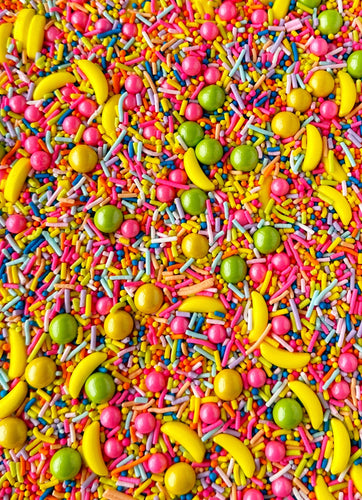 VARIETY SHAPED SPRINKLES INCLUDING BANANA SHAPED AND ROUND SHAPED. YELLOW BANANAS, LIME GREEN, LIGHT BLUE, LIGHT PURPLE, YELLOW, HOT PINK, DARK BLUE