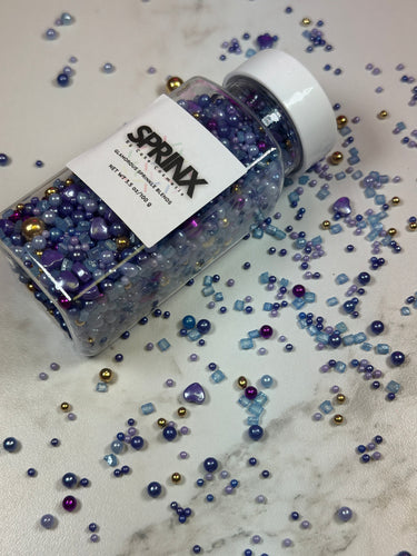 VARIETY SHAPED SPRINKLES INCLUDING SQUARE ROUND AND HEART SHAPED. METALLIC GOLD METALLIC PRUPLE METALLIC LIGHT BLUE METALLIC LAVENDAR