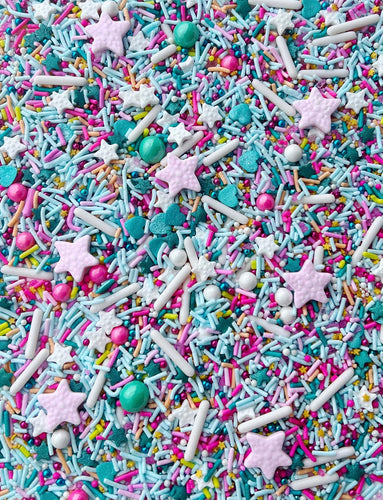 VARIETY SHAPED SPRINKLES INCLUDING HEARTS STARS AND ROUND SHAPED. WHITE TEAL HOT PINK LIGHT BLUE LAVENDAR