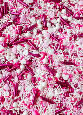 VARIETY SHAPED SPRINKLES INCLUDING RECTANGLE ROUND AND HEART SHAPED. METALLIC HOT PINK LIGHT PINK WHITE